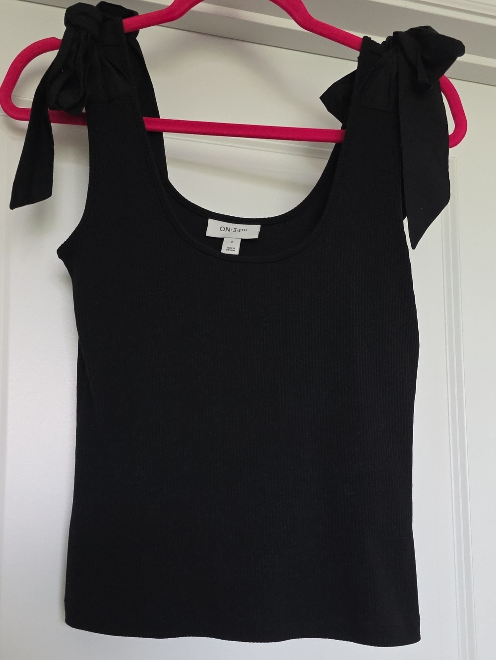 On 34th Black Ribbed Tank Top With Bows On Shoulder Straps.